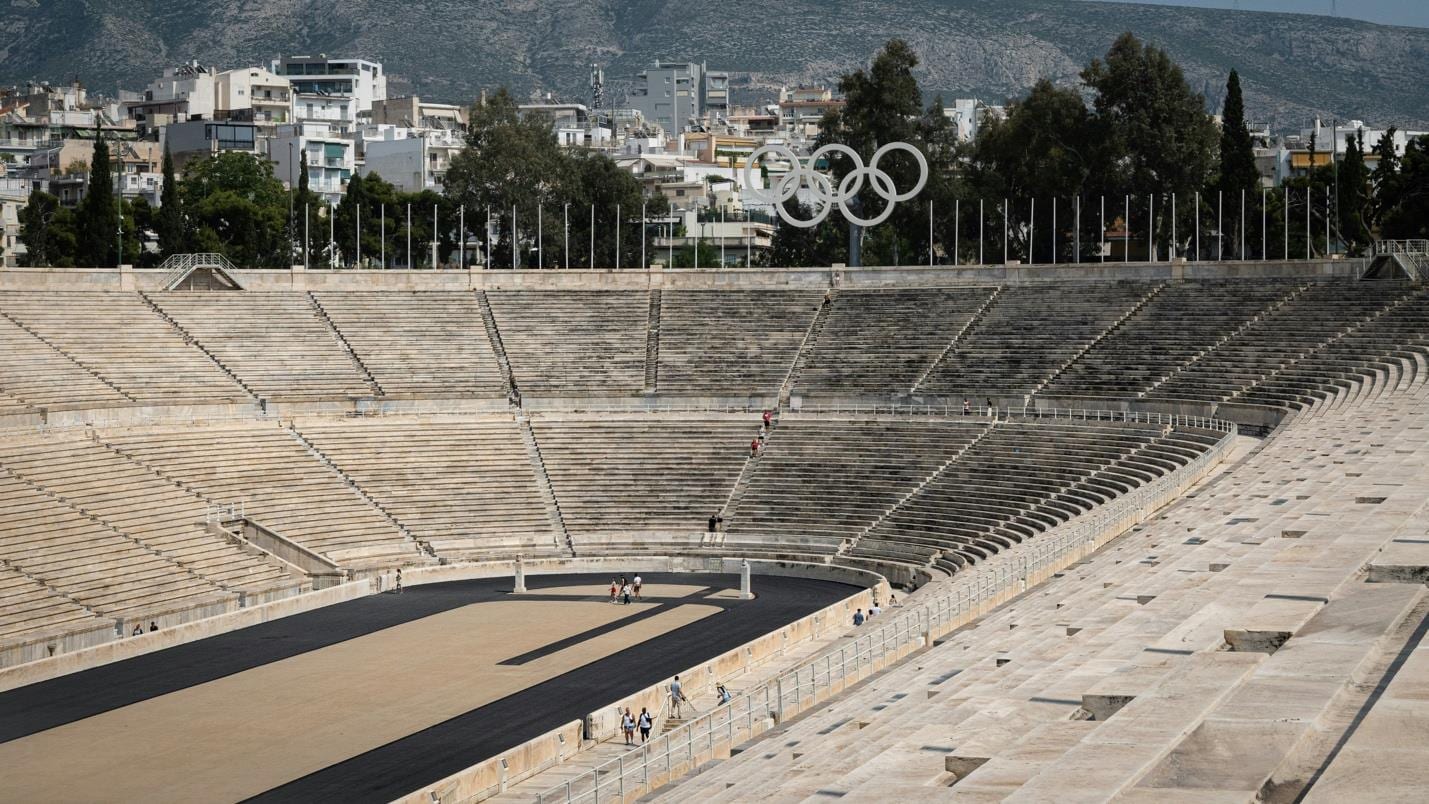 The Panathenaic Stadium in Athens, empty, with the surrounding city behind it.